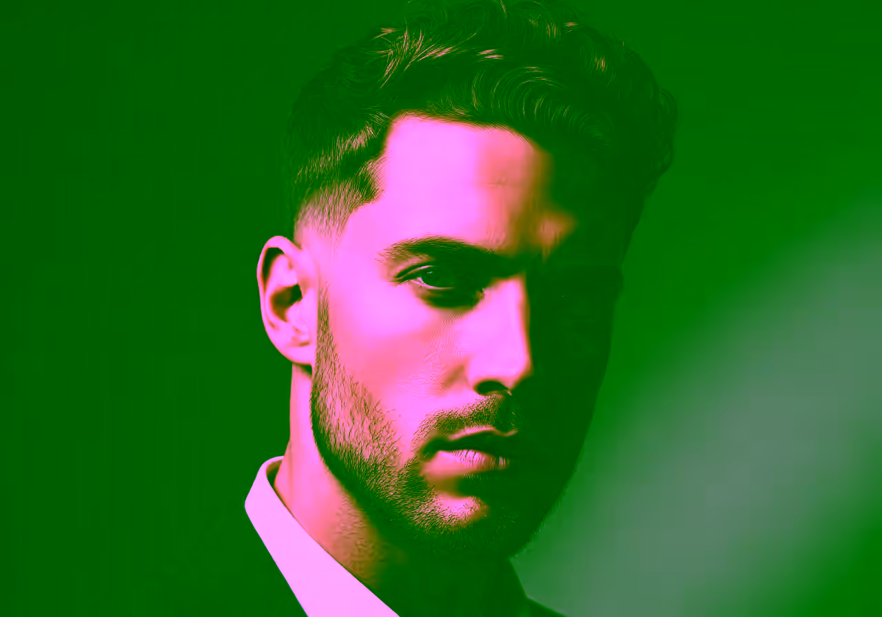 Curly low taper fade for men showing voluminous natural curls with subtle low fade